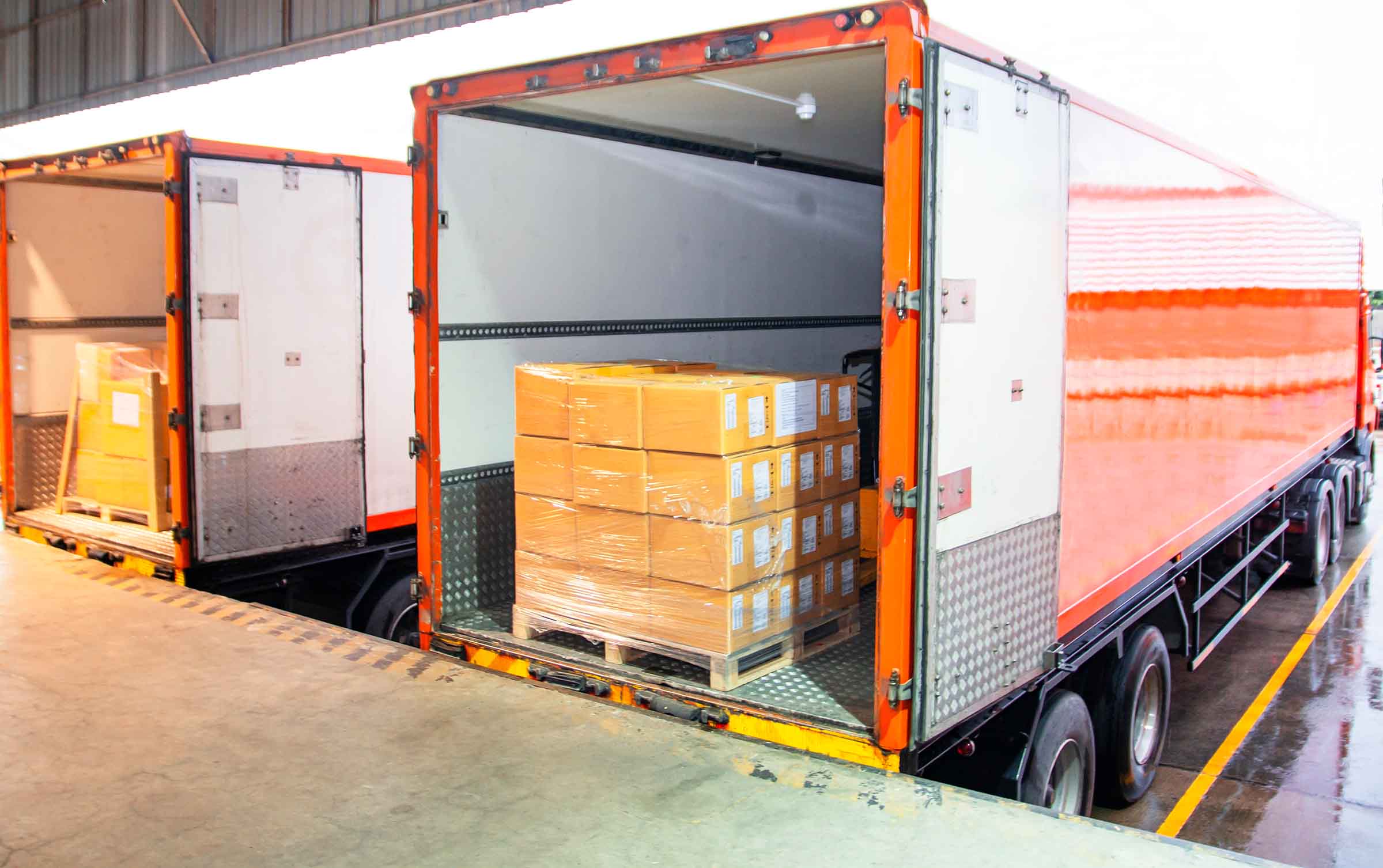 Cargo freight truck. Shipment, Delivery service. Logistics and transportation. Warehouse dock load pallet goods into shipping container truck. Stacked package boxes on pallet inside a truck.